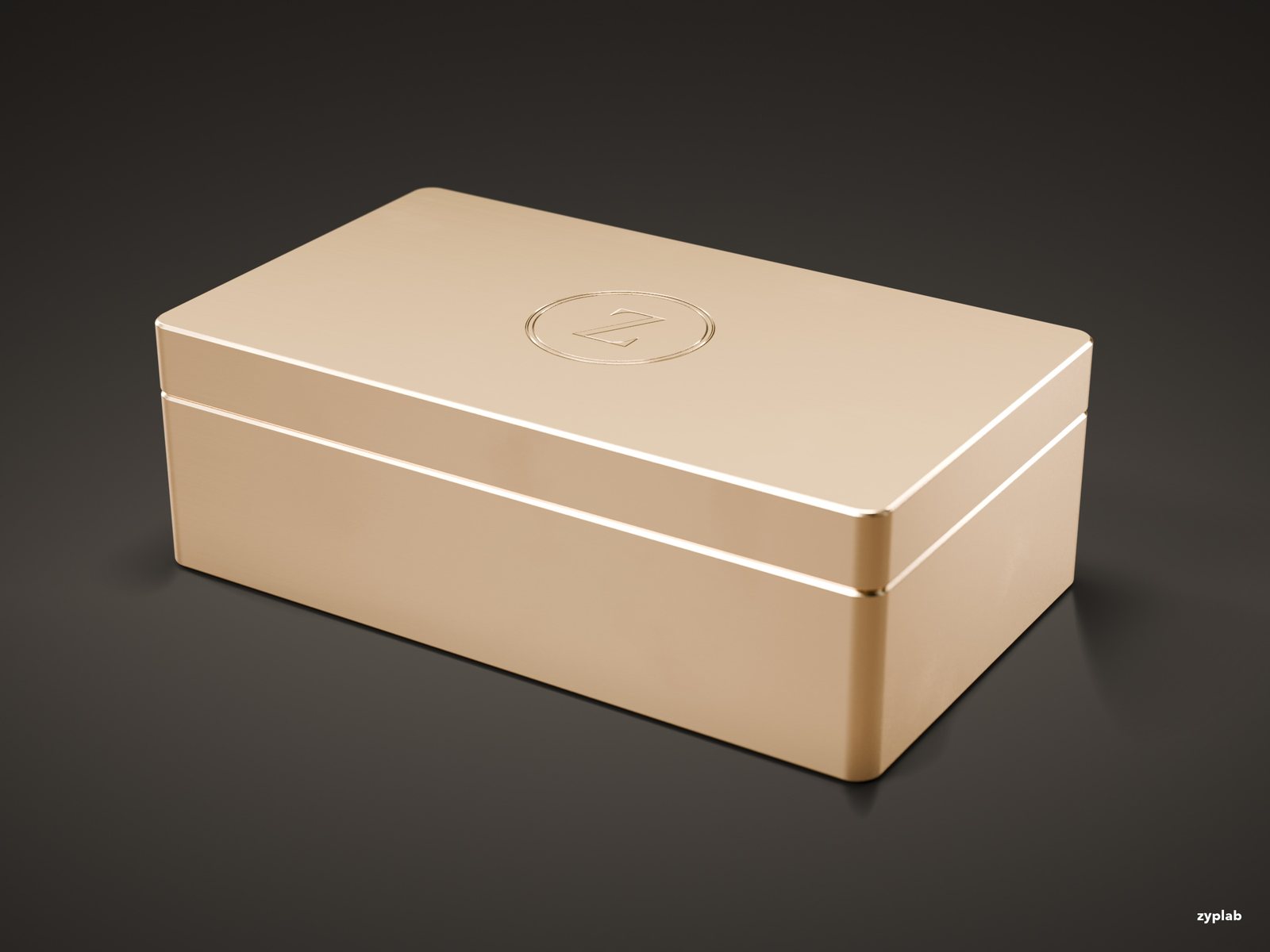 Closed brushed champagne-gold metal gift box with a debossed Z monogram