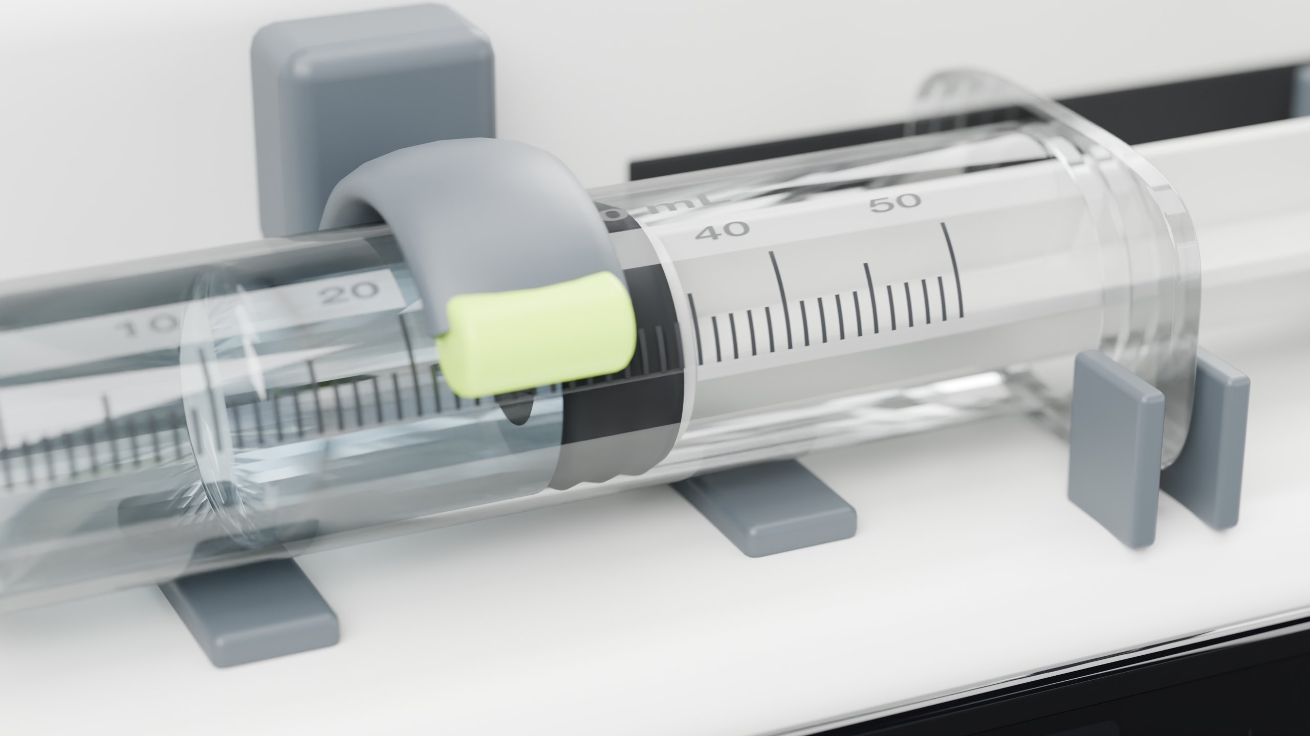 Close view of the loaded 50 mL syringe, barrel clamp and graduations
